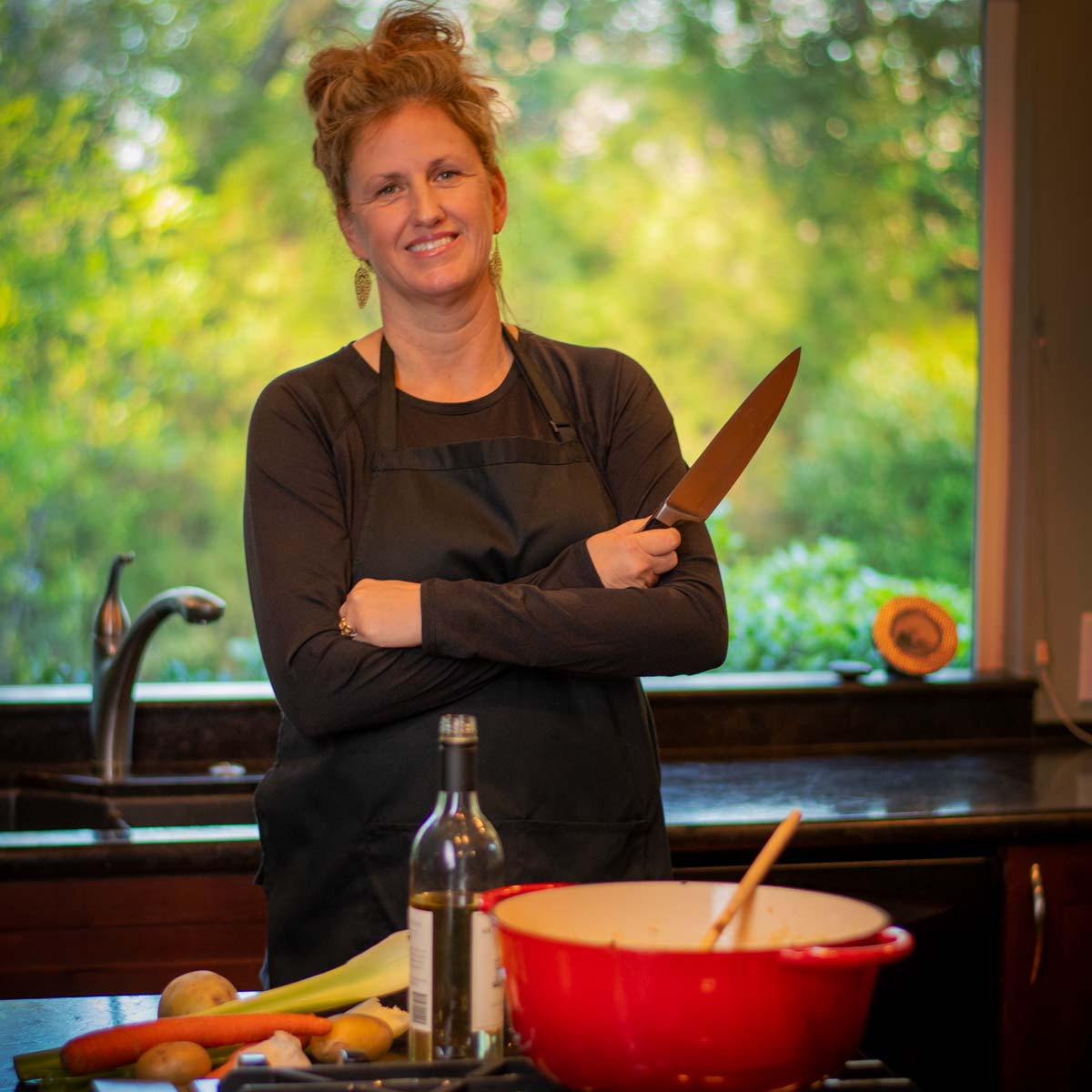 Marnie Coots in kitchen with knife and vegetables