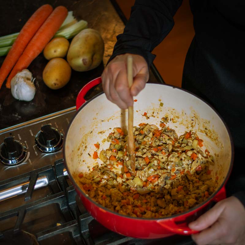 Fresh chopped vegetables in pot being stirred