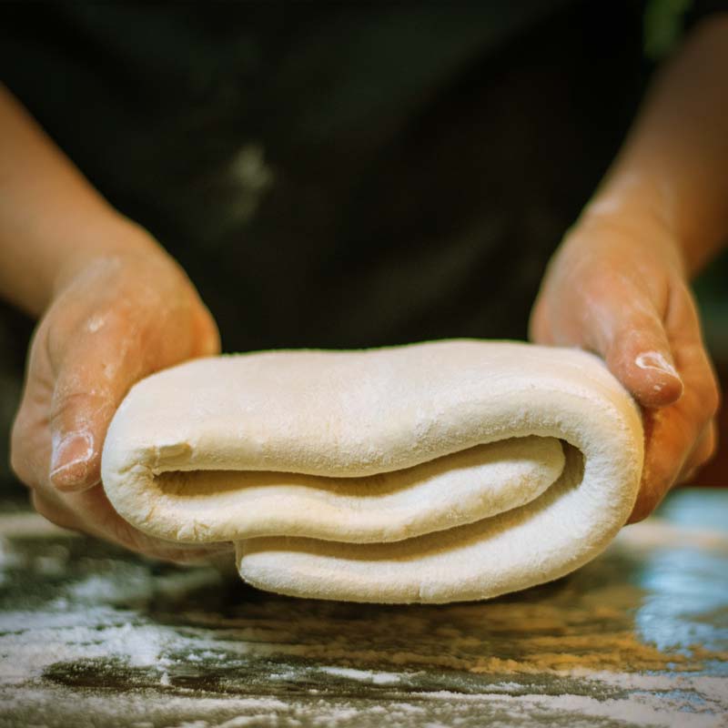 Pastry dough folded in hands