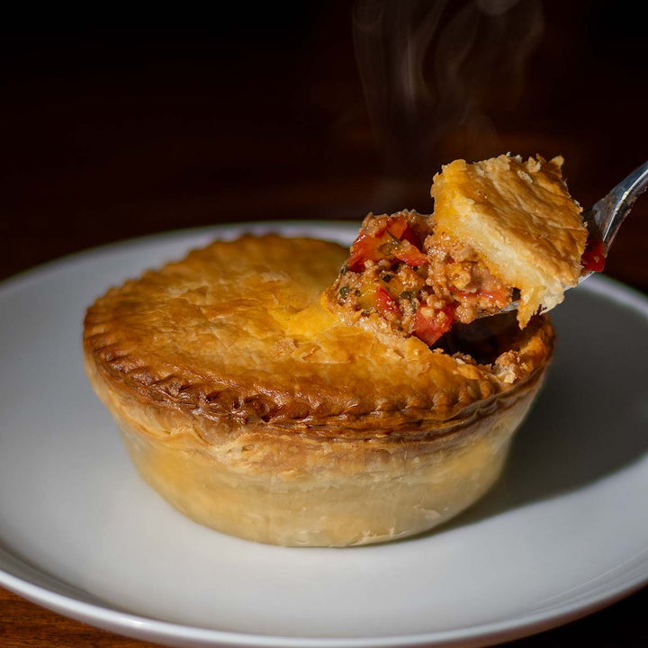 Steaming Italian pot pie with a fork on a plate